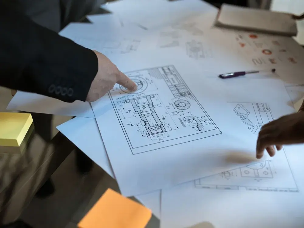 Detailed architectural blueprint being reviewed