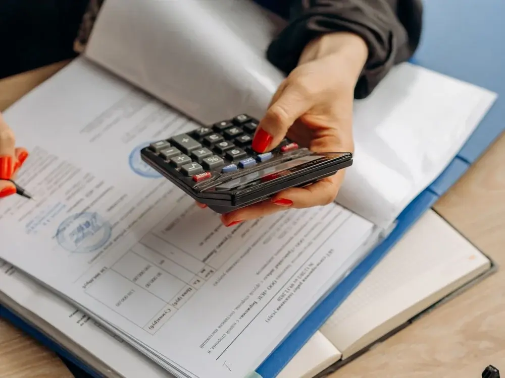 Calculator and paperwork for cost estimation