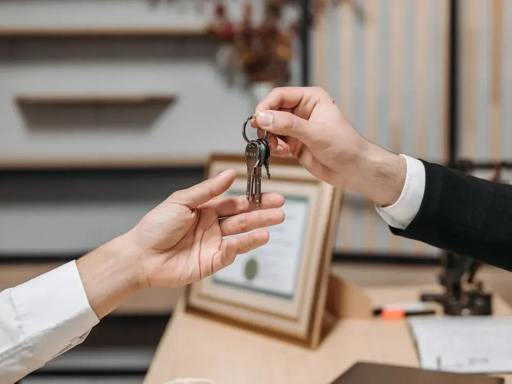 Professional handing over house keys to a client